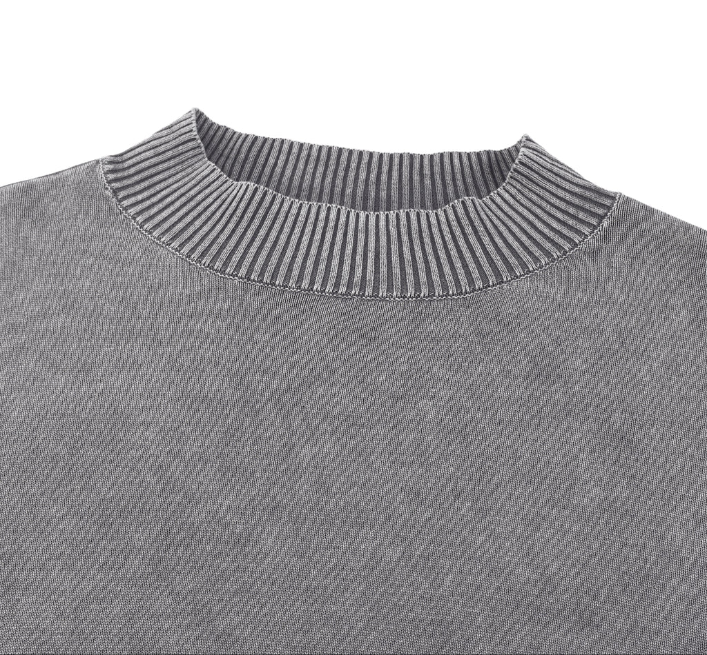 Close-up of a gray sweater with ribbed neckline on a white background